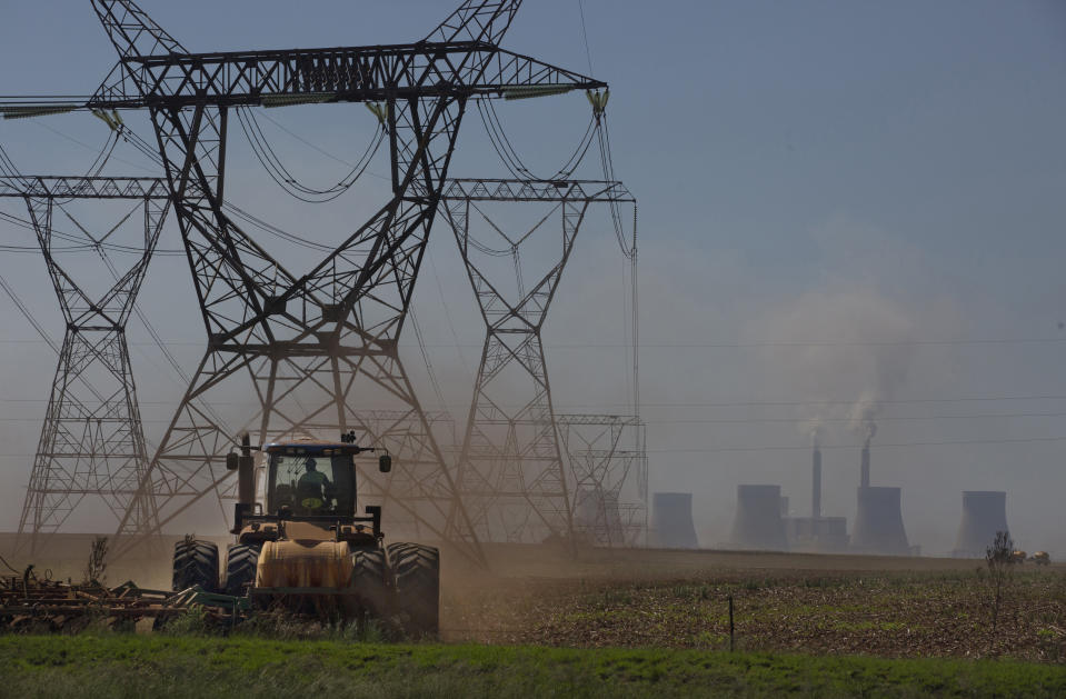 The land is ploughed under electrical pylons leading from a coal-powered electricity generating plant east of Johannesburg, on Nov. 17, 2022. The electricity shortages that plague many of Africa's 54 countries are a serious drain on the continent's economic growth. In recent years South Africa's power generation has become so inadequate that the continent's most developed economy must cope with rolling power blackouts of eight to 10 hours per day. (AP Photo/Denis Farrell)