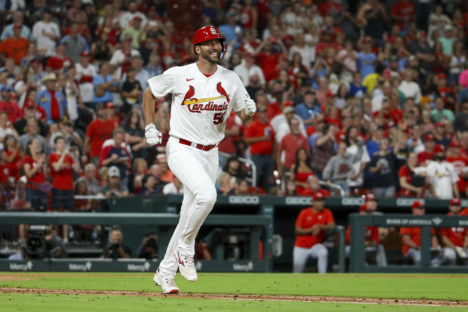 St. Louis Cardinals' Adam Wainwright smiles as he runs toward first base while grounding out during the sixth inning against the Cincinnati Reds, Friday, Sept. 29, 2023, in St. Louis. (AP Photo/Scott Kane)