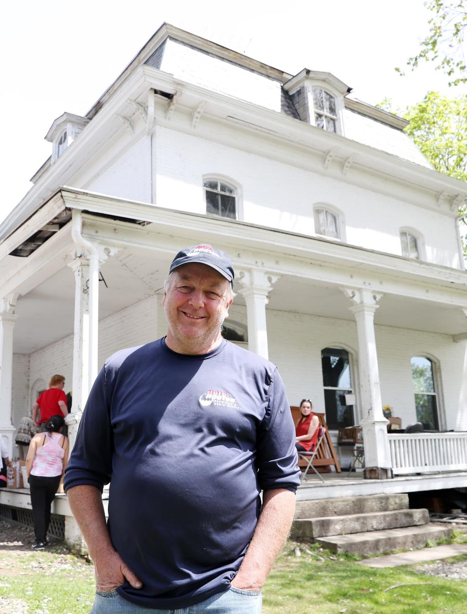 Richard Skjrli, pastor of Fuente de Gracia, in the village of Brewster, stand in front of the Lobdell house in the village  May 5, 2022. The Lobdell house is schedule for demolition in the revitalization plan.