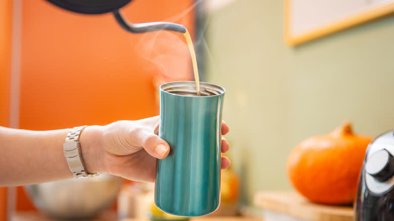 pouring liquid into thermos