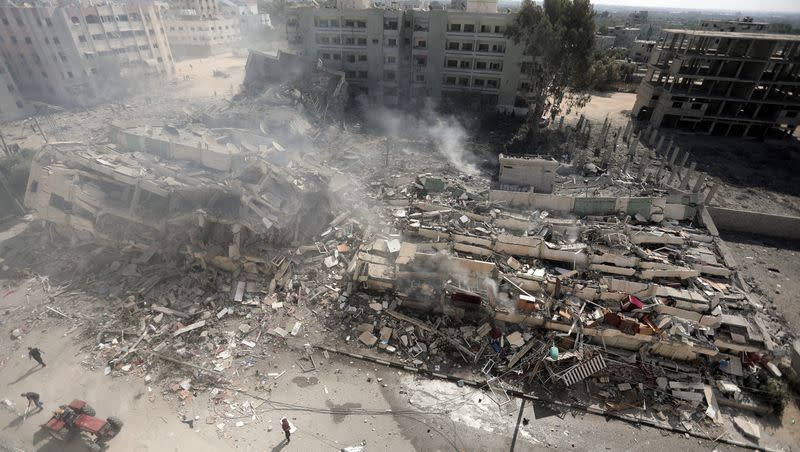 Smoke rises from destroyed buildings, following Israeli airstrikes on Gaza City, central Gaza Strip, Thursday, Oct. 19, 2023.