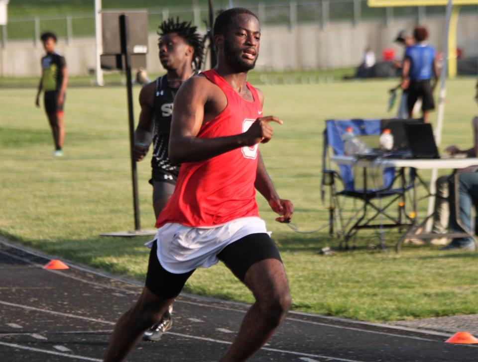 Chatham Glenwood senior sprinter Qwinsuan Anderson sprints to first place in the 100-meter dash at the Central State Eight Conference boys track and field meet in Decatur on Thursday, May 12.