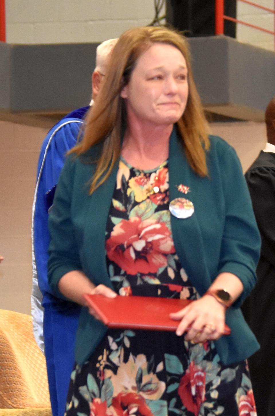 Amber Pitre receives a diploma on behalf of her daughter, Kennedi Foret, during Saturday's commencement. Kennedi died in a car crash in December before she could graduate.