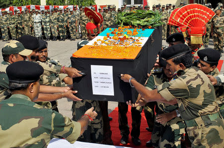 Indian Border Security Force (BSF) officers place the coffin of their fallen colleague, who died after shelling across the border between India and Pakistan, during a wreath laying ceremony at their headquarters on the outskirts of Jammu October 24, 2016. REUTERS/Mukesh Gupta