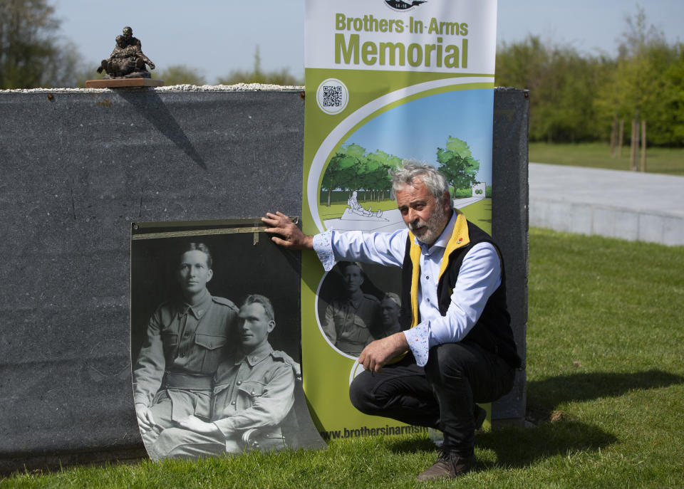 Johan Vandewalle sits near a photo of Australian brothers and World War I soldiers John "Jack" and Jim Hunter at the Brothers in Arms Memorial in Zonnebeke, Belgium, Thursday, April 22, 2021. Johan Vandewalle is leading a team of volunteers that has almost finished a 40 meter long memorial to Australian John "Jack" Hunter in Flanders Fields in Belgium, where Anzac forces also fought, some 2,750 kilometers (1,700 miles) west from Gallipoli along the immense frontline. On another Anzac Day turned lonesome by the global pandemic, solitary actions show all the more how the sacrifices of Australia and New Zealand during World War I are far from forgotten. (AP Photo/Virginia Mayo)