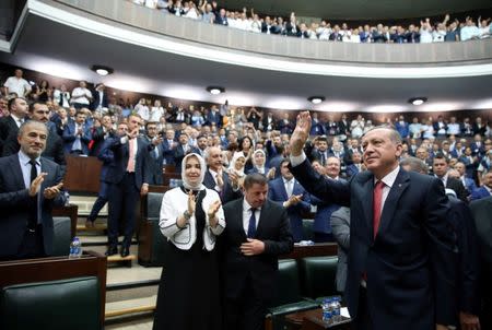 Turkish President Tayyip Erdogan greets members of parliament from his ruling AK Party during a meeting at the parliament in Ankara, Turkey July 25, 2017. Yasin Bulbul/Presidential Palace/Handout via REUTERS ATTENTION EDITORS - THIS IMAGE HAS BEEN SUPPLIED BY A THIRD PARTY. NO RESALES. NO ARCHIVES