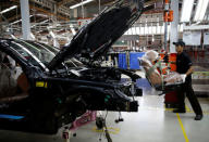 A worker prepares to install a seat in a locally assembled new BMW 7 Series on the production line at a Gaya Motor assembly plant in Jakarta, Indonesia November 30, 2016. REUTERS/Darren Whiteside