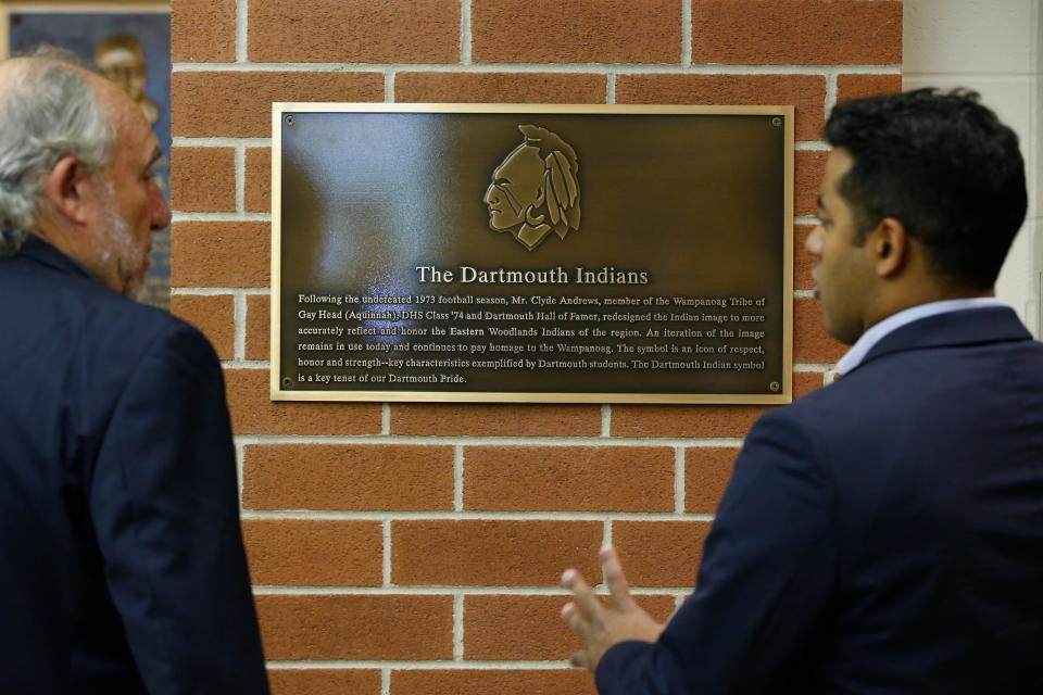 Dartmouth Select Board Chairman David Tatelbaum and Jacob Ventura, a Dartmouth High alum and Aquinnah Wampanoag member have a talk as they take a closer look at the plaque commemorating the Dartmouth Indian logo and the contributions of indigenous people. The plaque was unveiled in the Dartmouth High School lobby on Friday.