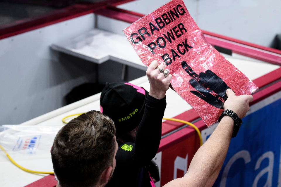 Security reaches for a protester's sign as President Trump speaks during a Keep America Great rally at the Giant Center in Hershey, Pennsylvania on December 10, 2019. (Photo: BRENDAN SMIALOWSKI via Getty Images)