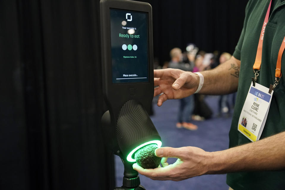 An exhibitor demonstrates the OneThird avocado ripeness checker during CES Unveiled before the start of the CES tech show, Tuesday, Jan. 3, 2023, in Las Vegas. More than a thousand startups are showcasing their products at the annual CES tech show in Las Vegas, hoping to create some buzz around their gadgets and capture the eyes of investors who can help their businesses grow.(AP Photo/John Locher, File)