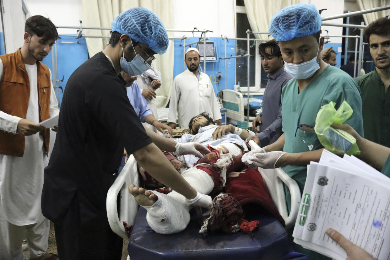 A victim receives medical assistance in a hospital after he was wounded in the deadly attacks outside the airport in Kabul, Afghanistan, Thursday, Aug. 26, 2021. Two suicide bombers and gunmen attacked crowds of Afghans flocking to Kabul's airport Thursday, transforming a scene of desperation into one of horror in the waning days of an airlift for those fleeing the Taliban takeover. (AP Photo/Khwaja Tawfiq Sediqi)