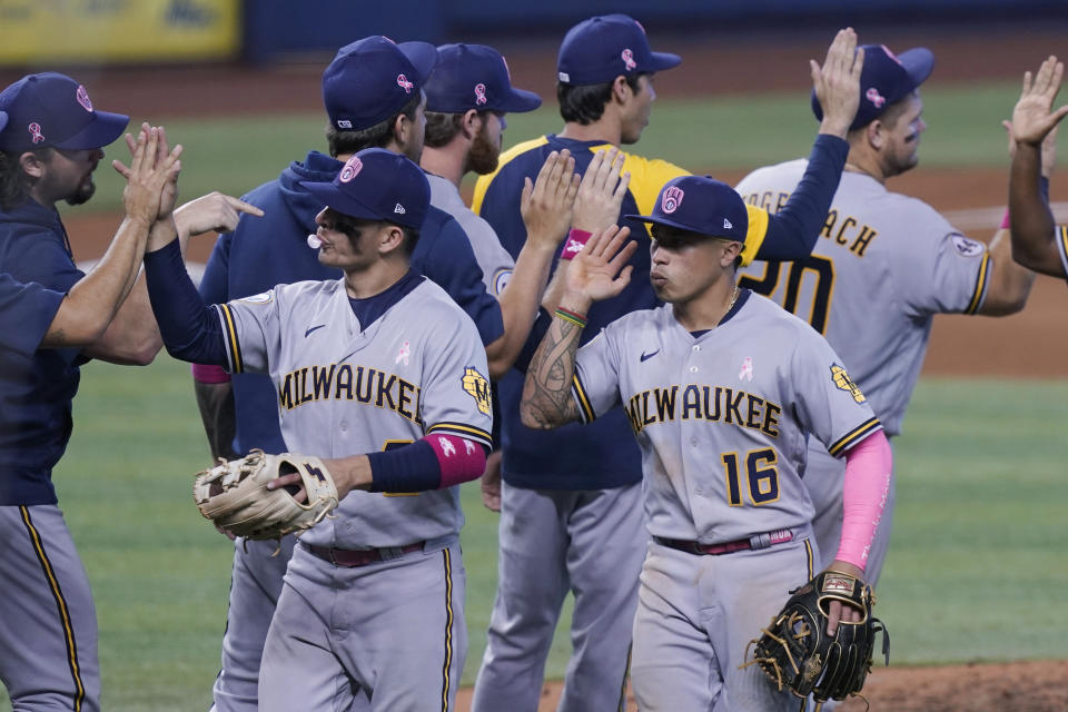 Milwaukee Brewers celebrate their win in 10 innings of a baseball game against the Miami Marlins, Sunday, May 9, 2021, in Miami. (AP Photo/Marta Lavandier)