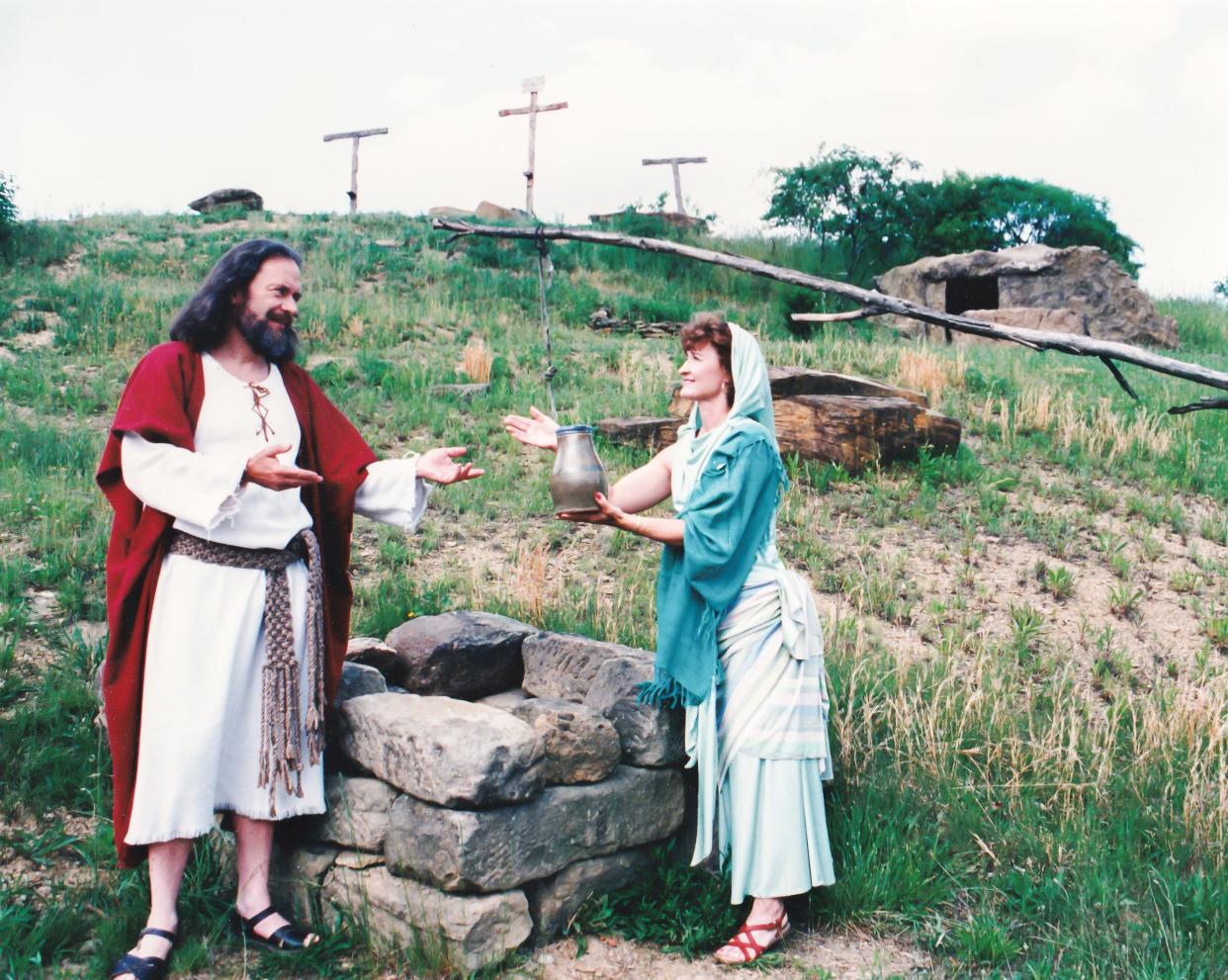 Cal Rice and Annette Ellwood act out a scene at The Living Word Outdoor Drama. The first person ever cast in the show was Ellwood. Rice was recruited from another passion play in Ohio by the drama's founder and played the role of Jesus for decades.