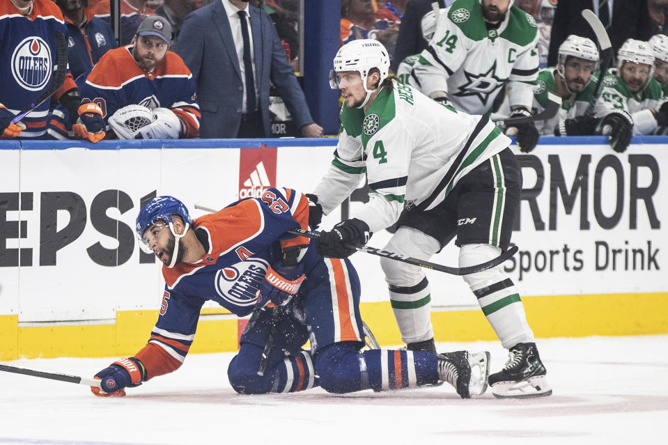 Dallas Stars' Miro Heiskanen (4) checks Edmonton Oilers' Darnell Nurse during the first period of Game 6 of the Western Conference finals of the NHL Stanley Cup playoffs in Edmonton, Alberta, Sunday June 2, 2024. (Jason Franson/The Canadian Press via AP)