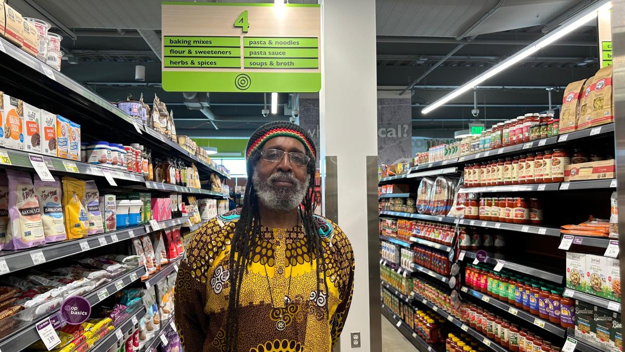 DBCFSN executive director Malik Yakini stands in an aisle at the opening of Detroit People's Food Co-Op on May 1, 2024.