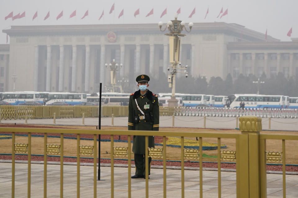 A Chinese paramilitary policeman stands watch near the Great Hall of the People where the annual National People's Congress is held in Beijing on Friday, March 5, 2021. The ruling Communist Party is aiming for economic growth "over 6%" as it rebounds from the coronavirus pandemic, Premier Li Keqiang said in a speech at China's ceremonial legislature Friday. (AP Photo/Ng Han Guan)