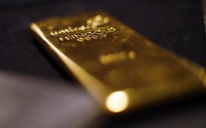 Gold bars are stacked at a safe deposit room of the ProAurum gold house in Munich March 6, 2014. REUTERS/Michael Dalder/Files