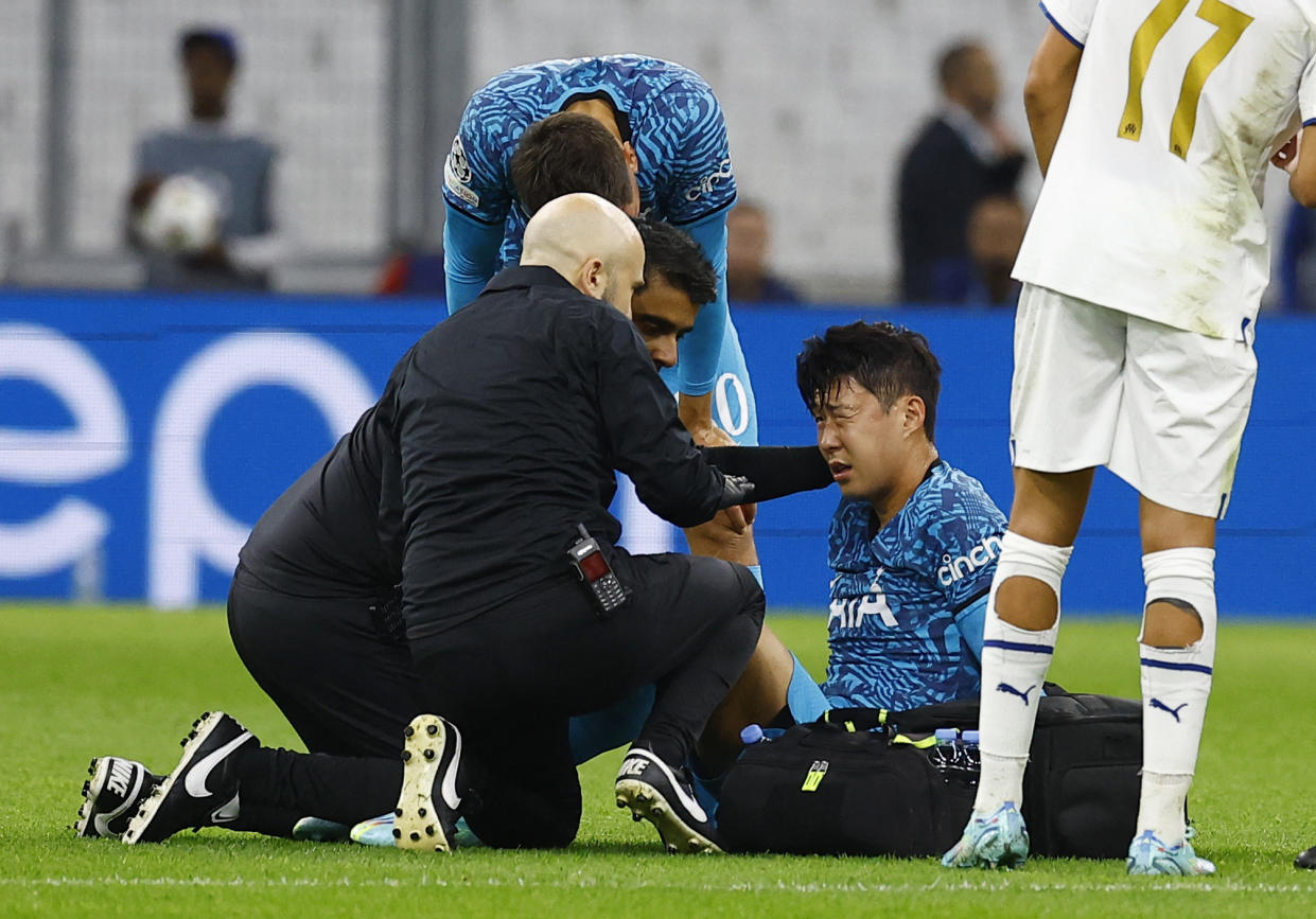 Tottenham Hotspur's Son Heung-min receives medical attention after suffering an injury in their Champions League match against Marseille.