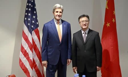 U.S. Secretary of State John Kerry (L) poses for photographs with Chinese Deputy Minister For Environment Protection Zhai Qing before holding a bilateral meeting to promote U.S. climate and environmental goals, at the Meeting of the Parties to the Montreal Protocol on the elimination of hydro fluorocarbons (HFCs) use in Rwanda's capital Kigali October 14, 2016. REUTERS/Cyril Ndegeya/Pool