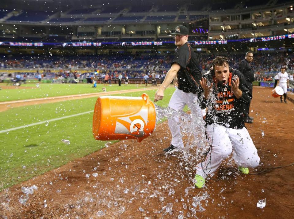 Tom Koehler, of the Miami Marlins, throws a cooler of ice water to teammate Jose Fernandez after the Marlins defeated the Atlanta Braves 12-11 on Friday, Sept. 25, 2015, at Marlins Park in Miami. Jose Fernandez became the first pitcher in the modern era to win his first 17 career home decisions.