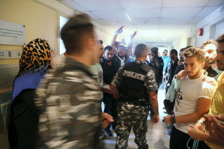 Protesters shout slogans while security officers walk by in the environment ministry in downtown Beirut, Lebanon September 1, 2015. REUTERS/Aziz Taher