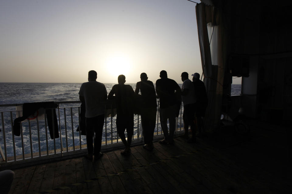Arab migrants, including three Libyans, two Tunisians and a Moroccan, gaze at the Mediterranean Sea, on the deck of the Geo Barents, a rescue vessel operated by MSF (Doctors Without Borders) off Libya, in the central Mediterranean route, Wednesday, Sept. 22, 2021. (AP Photo/Ahmed Hatem)