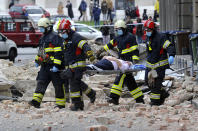 FILE - In this March 22, 2020, file photo, firefighters carry a person on a stretcher after a strong earthquake in Zagreb, Croatia. The virus outbreak is compromising the ability of nations to prepare for natural disasters and deal with the aftermath. Every year, the world contends with devastating typhoons, wildfires, tsunamis and earthquakes. (AP Photo/File)