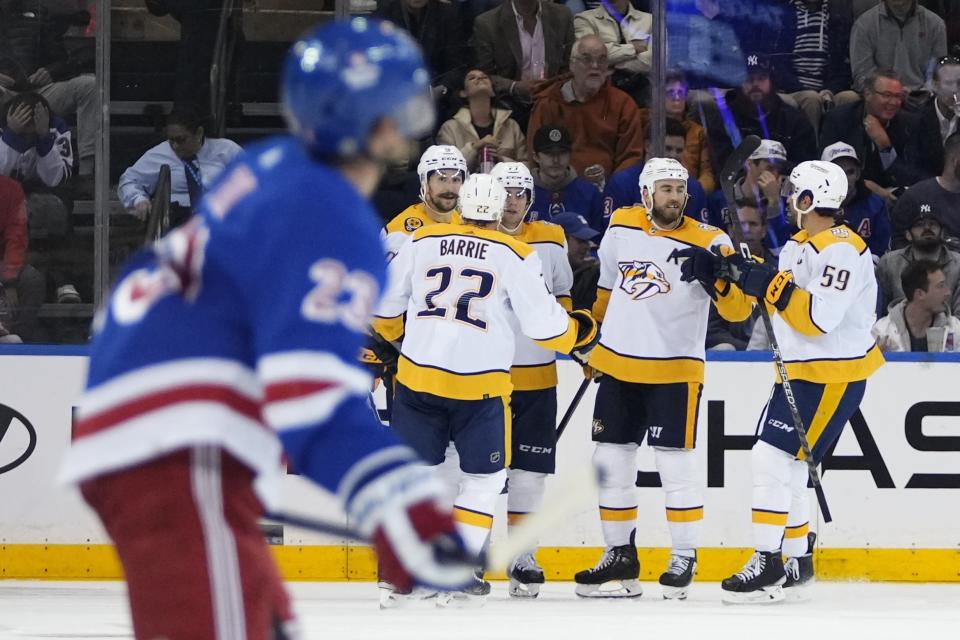 Nashville Predators' Ryan O'Reilly, second from right, celebrates with teammates Roman Josi (59) and Tyson Barrie after scoring a goal during the second period of an NHL hockey game against the New York Rangers Thursday, Oct. 19, 2023, in New York. (AP Photo/Frank Franklin II)