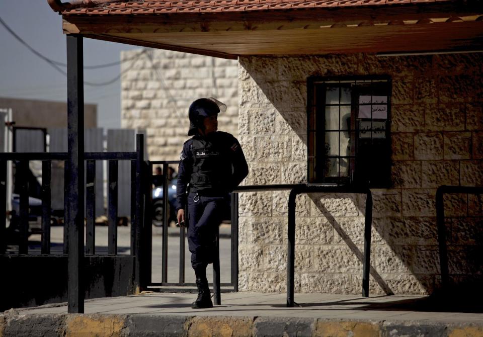 A Jordanian policeman stands guard during the trial of radical Sunni preacher, Abu Qatada, in Amman, Jordan, Thursday, Feb. 13, 2014. The 52-year-old Abu Qatada told reporters during a break in his trial on Thursday that he "supports" suicide attacks in Lebanon against Shiite targets. Abu Qatada has been described as a senior al-Qaida figure in Europe who had close ties to the late Osama bin Laden. (AP Photo/Mohammad Hannon)