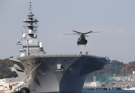 FILE PHOTO: A helicopter lands on the Izumo, Japan Maritime Self Defense Force's (JMSDF) helicopter carrier, at JMSDF Yokosuka base in Yokosuka, south of Tokyo, Japan, December 6, 2016. REUTERS/Kim Kyung-Hoon/File Photo TPX IMAGES OF THE DAY