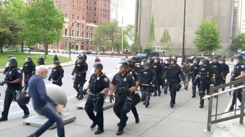 An elderly man falls after appearing to be shoved by riot police in Buffalo during a protest against the death in Minneapolis police custody of George Floyd