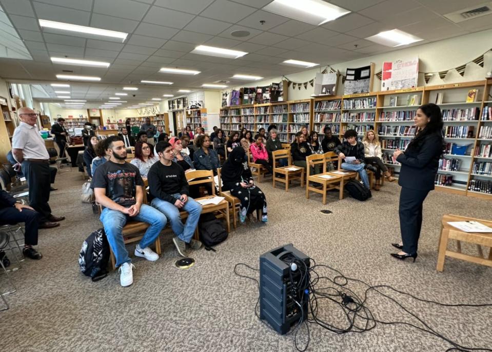 Marta Aparicio talks to students at Central High School about her journey from the school to becoming a U.S. diplomat.