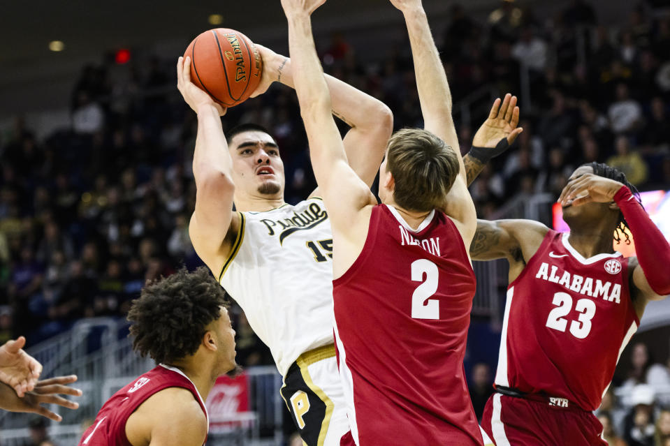 Purdue center Zach Edey (15) shoots while defended by Alabama forward Grant Nelson (2), forward Nick Pringle (23) and guard Mark Sears (1) during the second half of an NCAA college basketball game in Toronto, Saturday, Dec. 9, 2023. (Christopher Katsarov/The Canadian Press via AP)