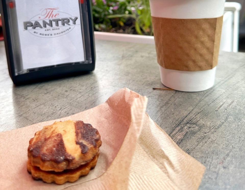 A swirled, crispy sandwich cookie and caramel-flavored coffee at The Pantry by Rose's Daughter in downtown Delray Beach.