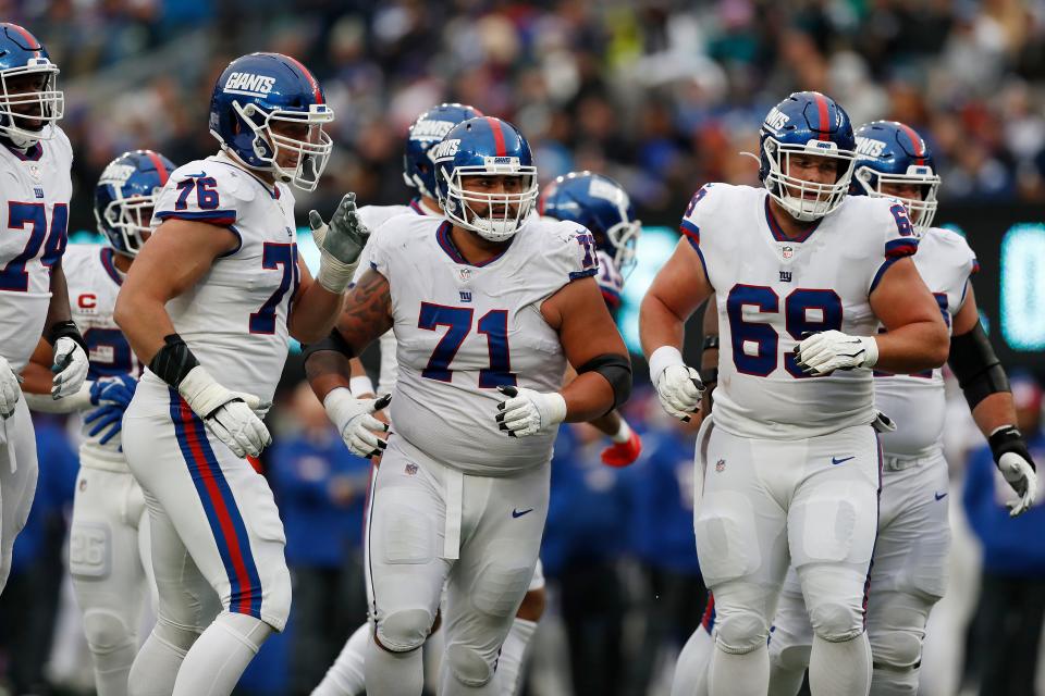 New York Giants offensive tackle Nate Solder (76), New York Giants guard Will Hernandez (71), and New York Giants center Billy Price (69) run towards the line of scrimmage before a play during an NFL football game against the Philadelphia Eagles, Sunday, Nov. 28, 2021, in East Rutherford, N.J. The New York Giants defeated the Philadelphia Eagles 13-7.