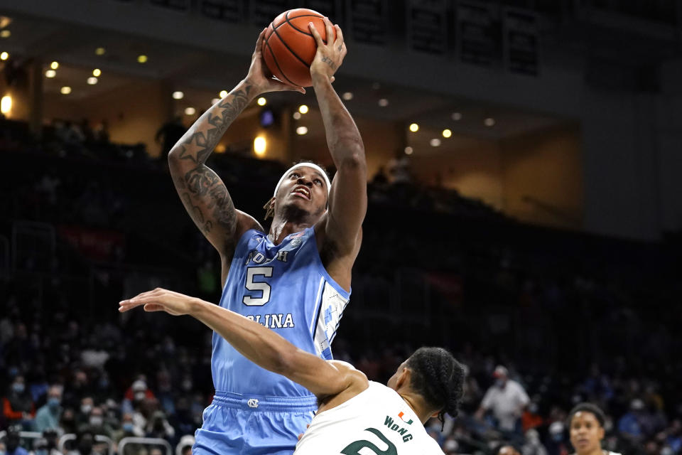 North Carolina forward Armando Bacot (5) shoots over Miami guard Isaiah Wong (2) during the first half of an NCAA college basketball game, Tuesday, Jan. 18, 2022, in Coral Gables, Fla. (AP Photo/Lynne Sladky)