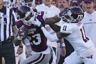 Mississippi State running back Dillon Johnson fights off Texas A&M defensive back Deuce Harmon during the second half of an NCAA college football game in Starkville, Miss., Saturday, Oct. 1, 2022. (AP Photo/Rogelio V. Solis)