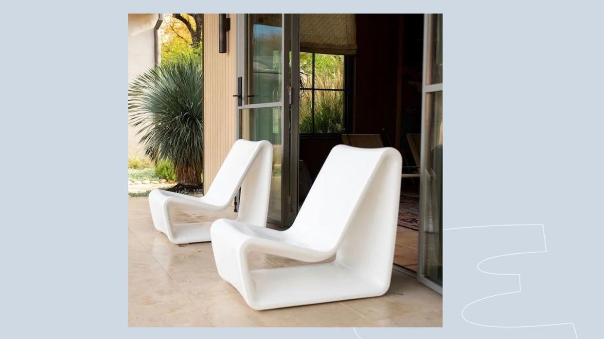 a group of white chairs in a room with a glass door