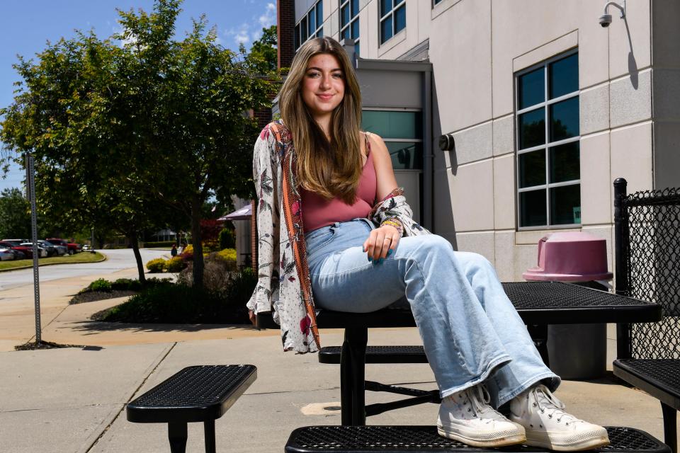 Anna Castro Spratt, 16, Greenville's first Youth Poet Laureate, poses for a portrait outside of the Fine Arts Center at Wade Hampton High School on Wednesday, May 4, 2023.