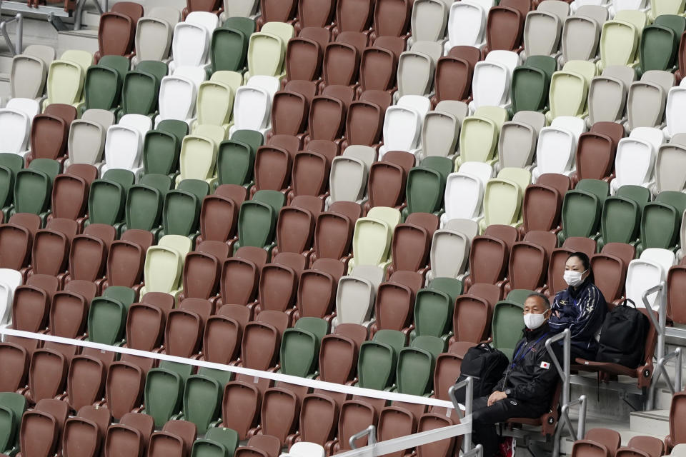 A support team watch an athletics test event for Tokyo 2020 Paralympics Games at the National Stadium in Tokyo on Tuesday, May 11, 2021. The pressure of hosting an Olympics during a still-active pandemic is beginning to show in Japan. The games begin July 23, with organizers determined they will go on, even with a reduced number of spectators or possibly none at all.(AP Photo/Shuji Kajiyama)