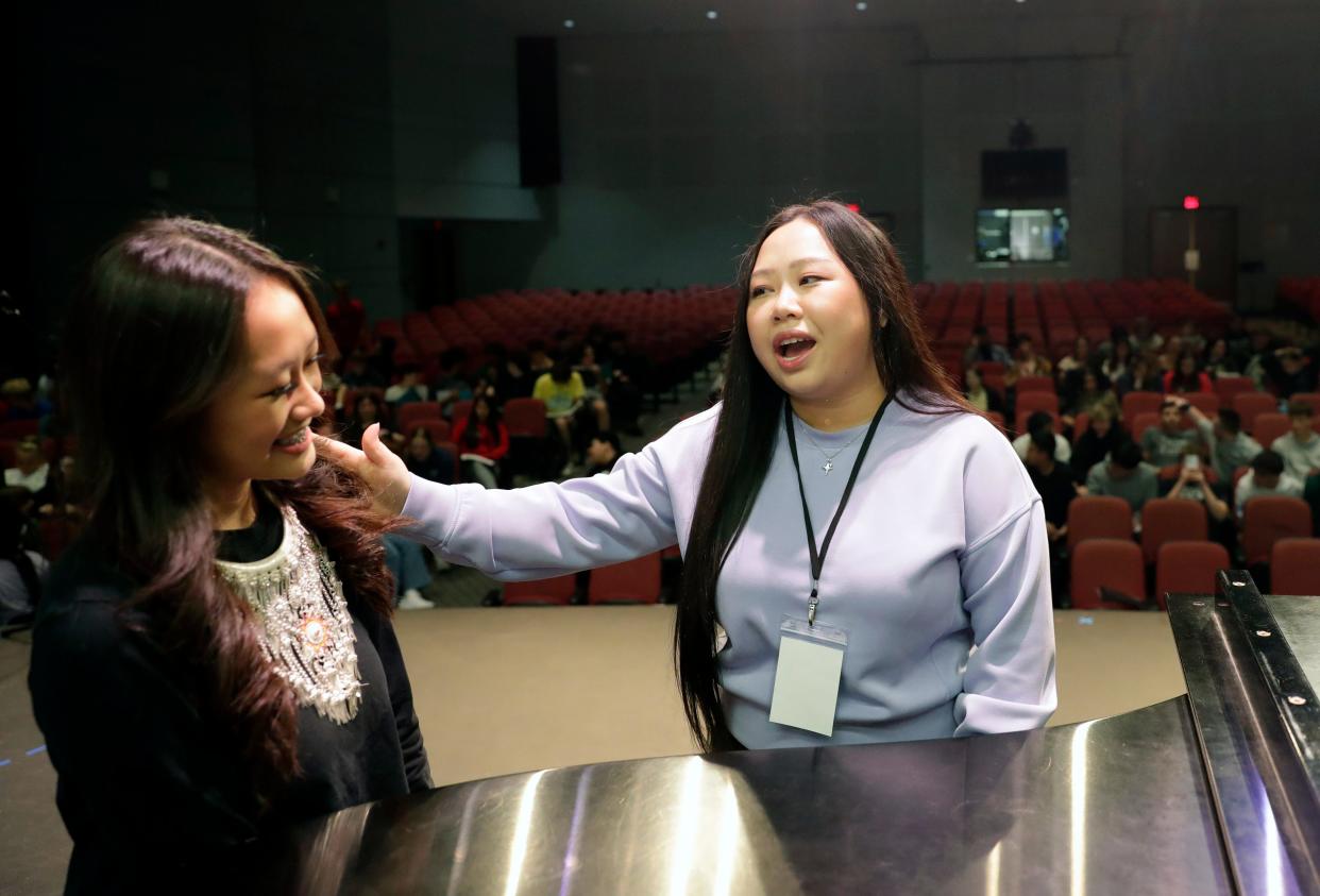 Singer Maa Vue, right, compliments student Mali Lor at the start of a rehearsal for the upcoming “Mirrors and Windows” concert on May 10, 2024, at Appleton North High School in Appleton, Wisconsin. Lor reached out to Vue regarding using her music in their upcoming concert.