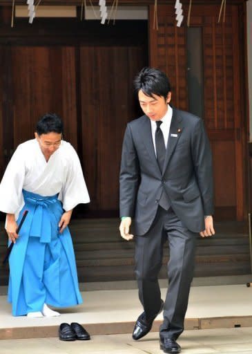 Shinjiro Koizumi (R), Japanese lawmaker and son of former Prime Minister Junichiro Koizumi, leaves the controversial Yasukuni shrine after honouring the dead on the 67th anniversary of Japan's surrender in World War II, in Tokyo, on August 15