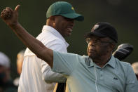 FILE - Lee Elder gestures as he arrives for the ceremonial tee shots before the first round of the Masters golf tournament on Thursday, April 8, 2021, in Augusta, Ga. Elder broke down racial barriers as the first Black golfer to play in the Masters and paved the way for Tiger Woods and others to follow. The PGA Tour confirmed Elder’s death, which was first reported by Debert Cook of African American Golfers Digest. No cause or details were immediately available, but the tour said it spoke with Elder's family. He was 87. (AP Photo/Charlie Riedel, File)