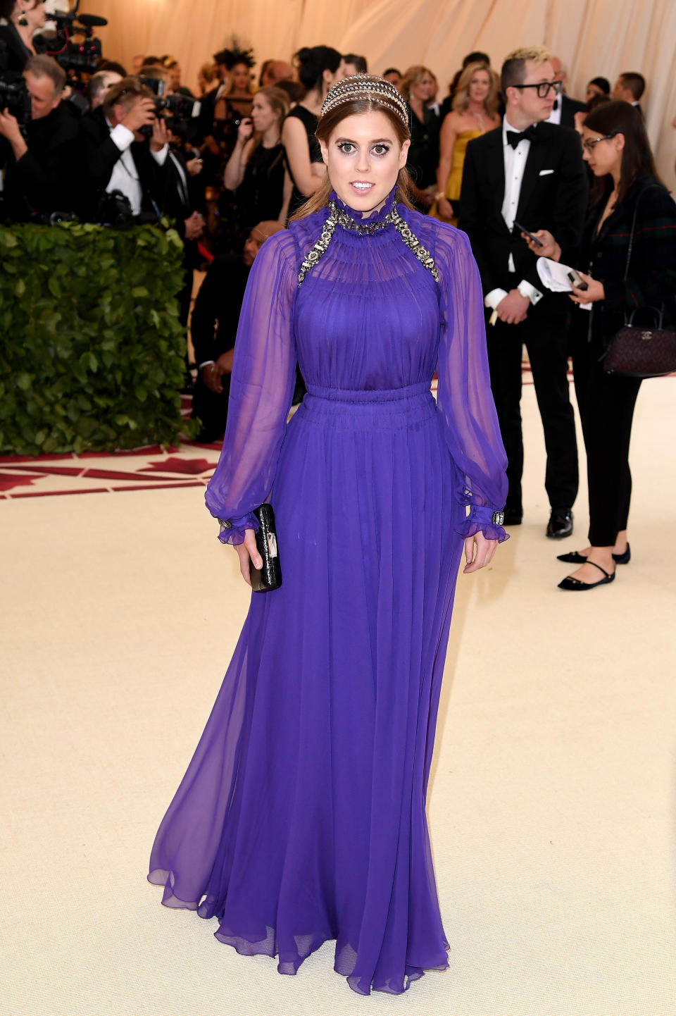 <p>Royalty arrived on the Met Gala red capet in the form of Princess Beatrice, who wore a purple gown with long schiffon sleeves and gold headpice. Photo: Getty Images </p>