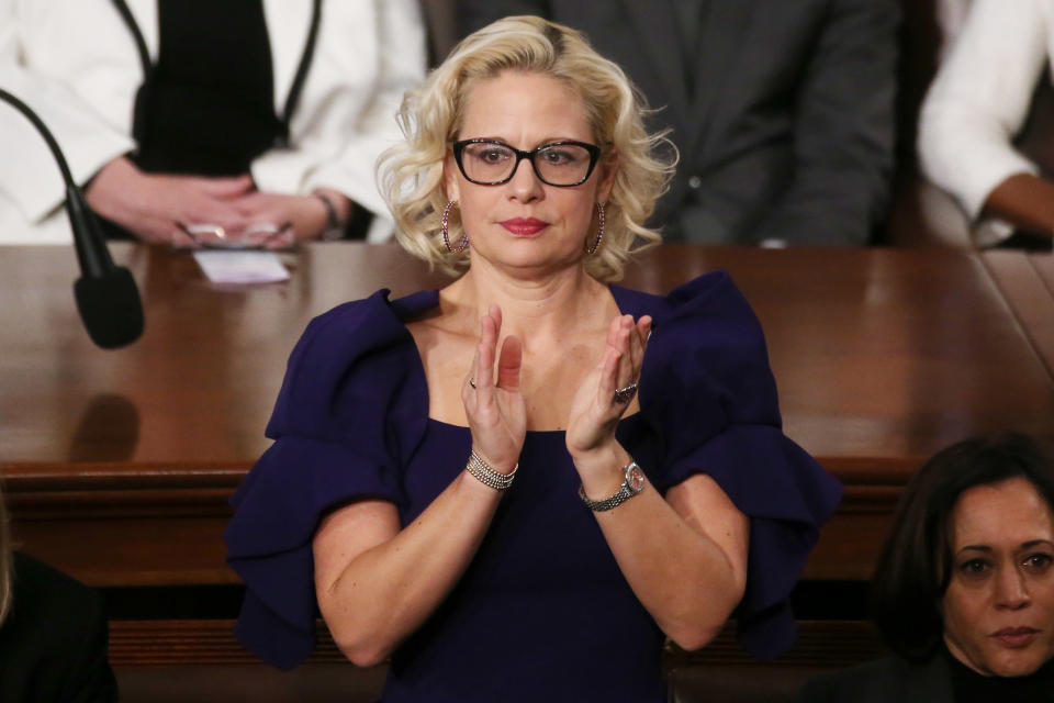 WASHINGTON, DC - FEBRUARY 04: Sen. Krysten Sinema (D-AZ) applauds during the State of the Union address in the chamber of the U.S. House of Representatives on February 04, 2020 in Washington, DC.  President Trump delivers his third State of the Union to the nation the night before the U.S. Senate is set to vote in his impeachment trial.  (Photo by Mario Tama/Getty Images)