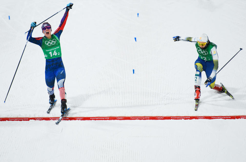 Jessica Diggins of the United States (L) stretches across the finish line to win gold ahead of Stina Nilsson of Sweden during the Cross Country Ladies’ Team Sprint Free Final on day 12 of the PyeongChang 2018 Winter Olympic Games. (Getty Images)