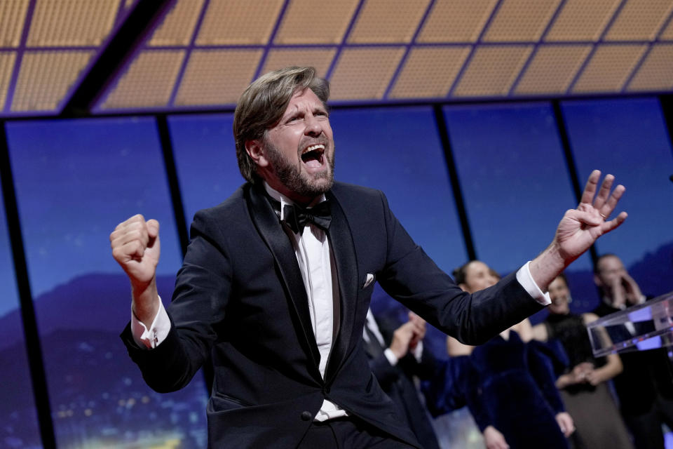 Writer/director Ruben Ostlund celebrates after winning the Palme d'Or for 'Triangle of Sadness' during the awards ceremony of the 75th international film festival, Cannes, southern France, Saturday, May 28, 2022. (Photo by Joel C Ryan/Invision/AP)