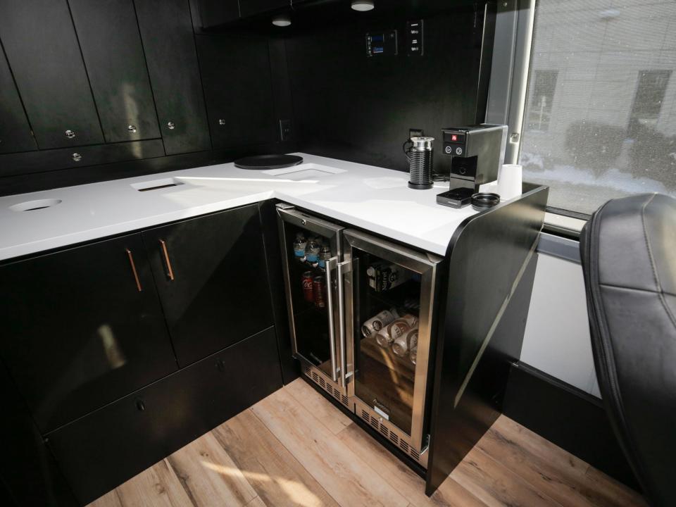 The galley at the rear of the bus. There's a coffee maker and a mini fridge.