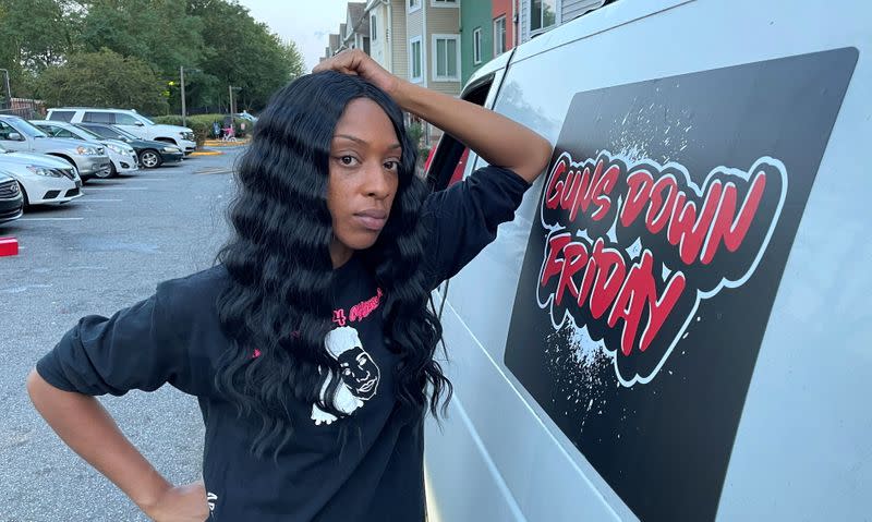 Community activist Jawanna Hardy leans on the "Guns Down Friday" van