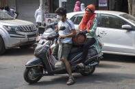 MUMBAI, INDIA - MARCH 23: People carry gas cylinder during lockdown due to Covid 19 pandemic at Girgaum, on March 23, 2020 in Mumbai, India. (Photo by Pratik Chorge/Hindustan Times via Getty Images)